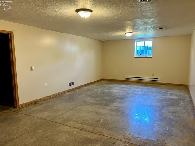 3106 E County Road 50, Tiffin, OH 44883 - unfurnished room with a baseboard heating unit, concrete flooring, and a textured ceiling