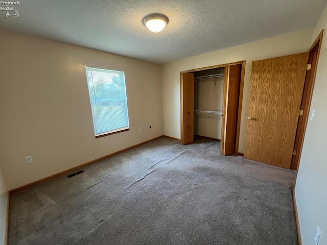 3106 E County Road 50, Tiffin, OH 44883 - unfurnished bedroom featuring carpet, a textured ceiling, and a closet