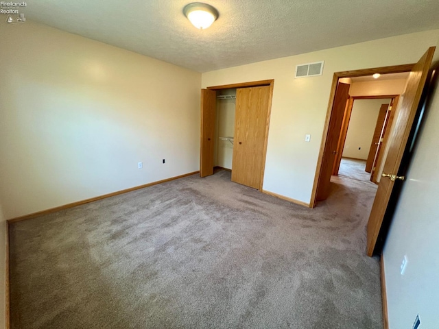 3106 E County Road 50, Tiffin, OH 44883 - unfurnished bedroom featuring carpet, a closet, and a textured ceiling