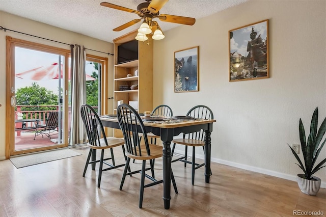 693 Delwood Ct, Highlands Ranch, CO 80126 - dining room featuring light wood finished floors, a textured ceiling, and a ceiling fan