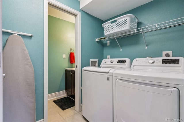693 Delwood Ct, Highlands Ranch, CO 80126 - laundry room with washer and clothes dryer and light tile patterned flooring