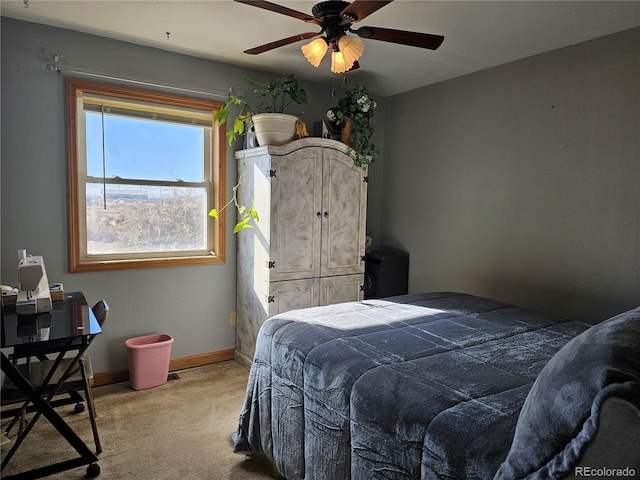 bedroom with ceiling fan and light carpet