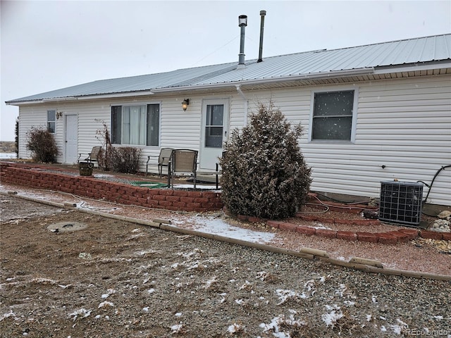 rear view of property featuring central AC unit