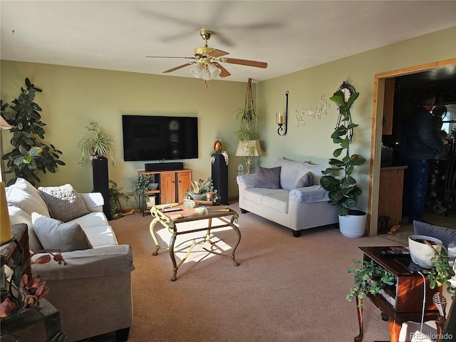 carpeted living room with ceiling fan