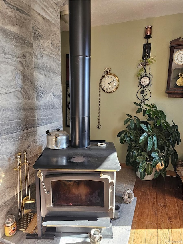 details featuring hardwood / wood-style flooring and a wood stove