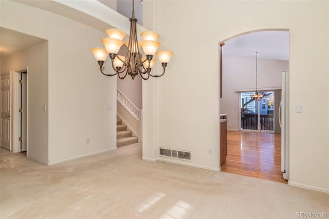 interior space with high vaulted ceiling and a chandelier