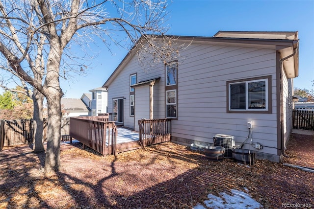 rear view of property with central AC