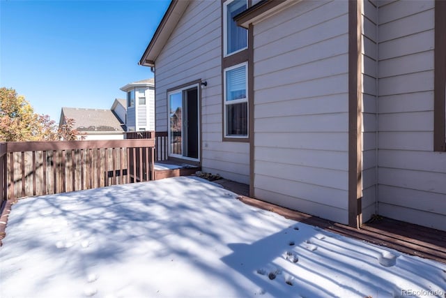 view of snow covered exterior with a wooden deck