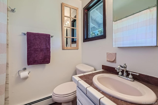 bathroom with vanity, toilet, and a baseboard radiator