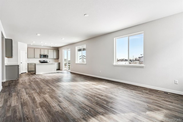 unfurnished living room featuring dark wood-type flooring