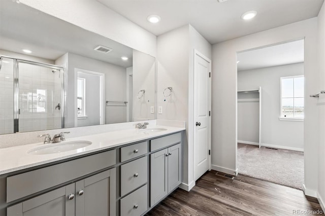 bathroom featuring vanity, hardwood / wood-style floors, and an enclosed shower