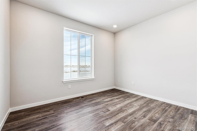 empty room featuring dark hardwood / wood-style flooring