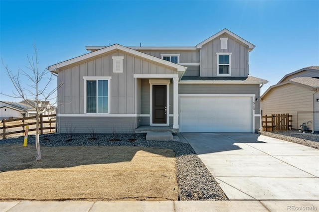 view of front of house featuring a garage, concrete driveway, board and batten siding, and fence