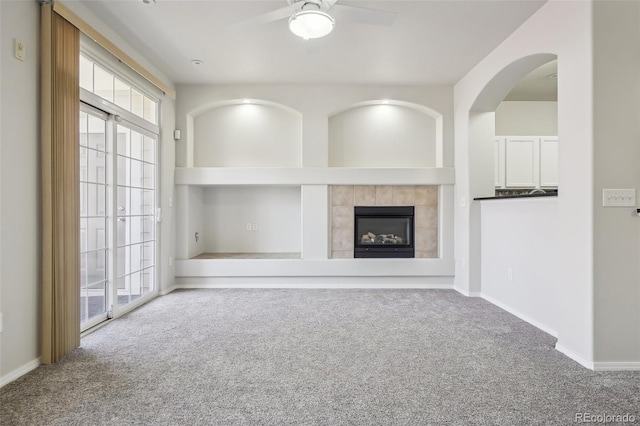 12711 Colorado Blvd Unit 1009, Thornton, CO 80241 - unfurnished living room with carpet flooring, ceiling fan, a tiled fireplace, and built in features