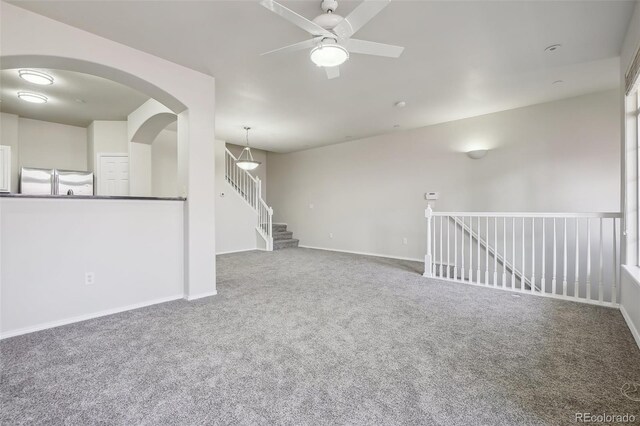 12711 Colorado Blvd Unit 1009, Thornton, CO 80241 - empty room featuring carpet, a ceiling fan, baseboards, and arched walkways