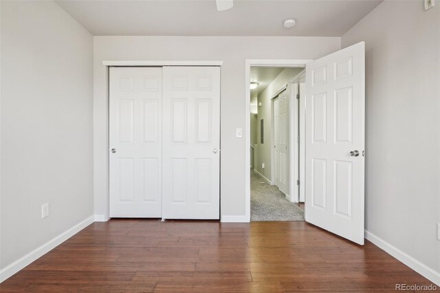 12711 Colorado Blvd Unit 1009, Thornton, CO 80241 - unfurnished bedroom with baseboards, dark wood-type flooring, and a closet