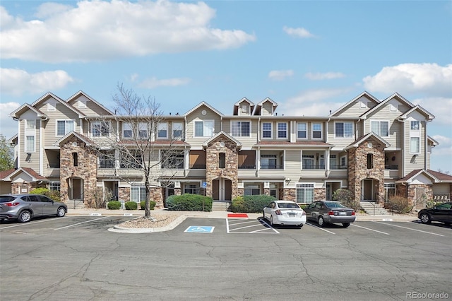 12711 Colorado Blvd Unit 1009, Thornton, CO 80241 - view of front of house with stone siding and uncovered parking