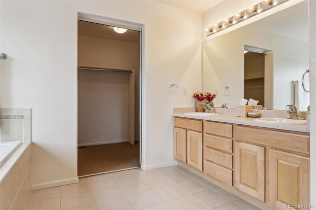 full bathroom with tile patterned floors, double vanity, and a sink