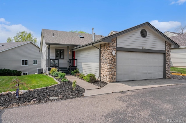 403 Captains Ct, Fort Collins, CO 80524 - view of front of house featuring central AC unit, an attached garage, a shingled roof, and a front yard