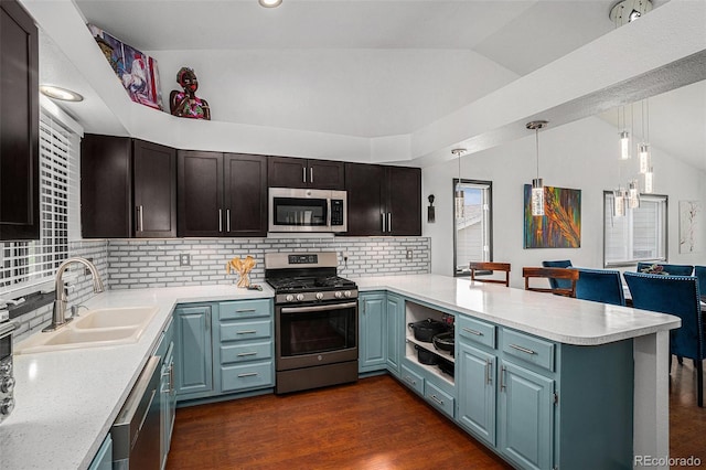 403 Captains Ct, Fort Collins, CO 80524 - kitchen featuring stainless steel appliances, a sink, lofted ceiling, a peninsula, and light countertops