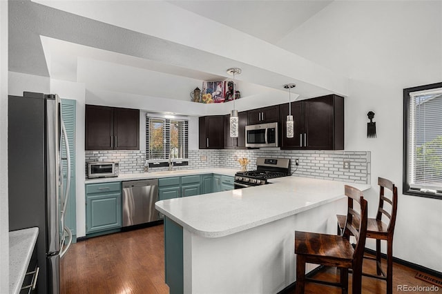 403 Captains Ct, Fort Collins, CO 80524 - kitchen featuring stainless steel appliances, a peninsula, decorative backsplash, light countertops, and a sink