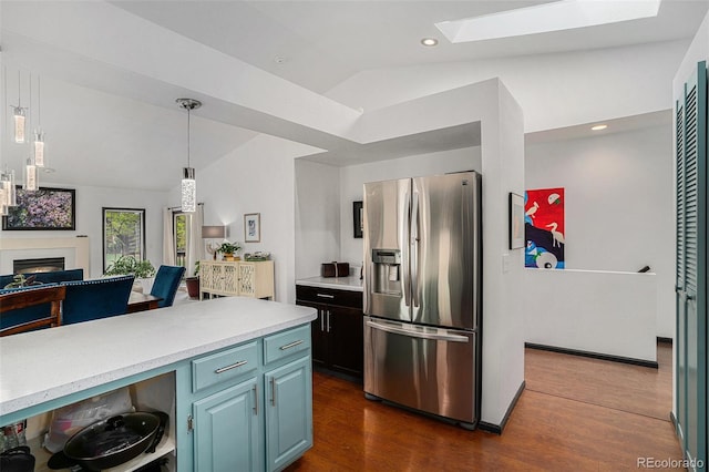 403 Captains Ct, Fort Collins, CO 80524 - kitchen with stainless steel fridge with ice dispenser, vaulted ceiling, a skylight, dark wood finished floors, and light countertops