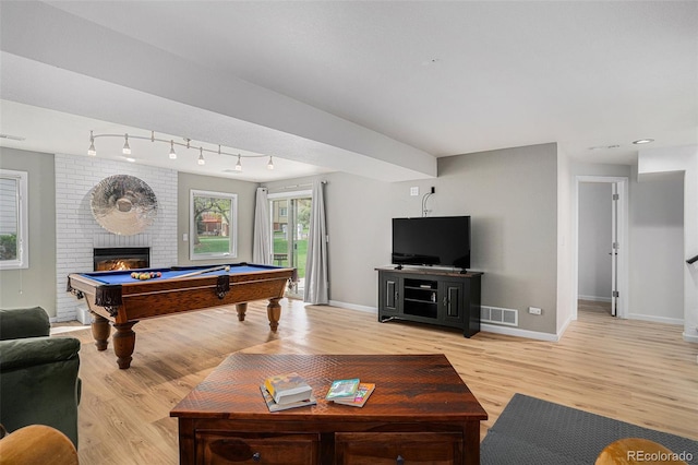 403 Captains Ct, Fort Collins, CO 80524 - living room featuring light wood finished floors, baseboards, pool table, and a fireplace