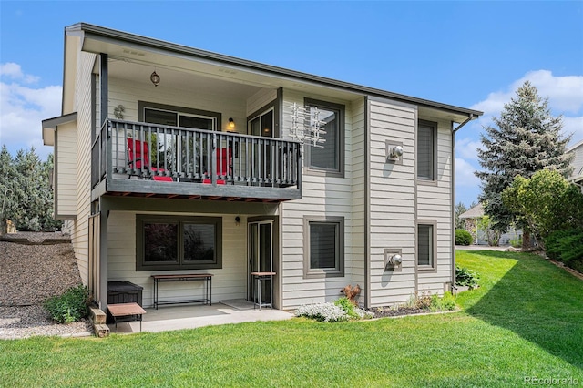 403 Captains Ct, Fort Collins, CO 80524 - back of house featuring a balcony, a lawn, and a patio area