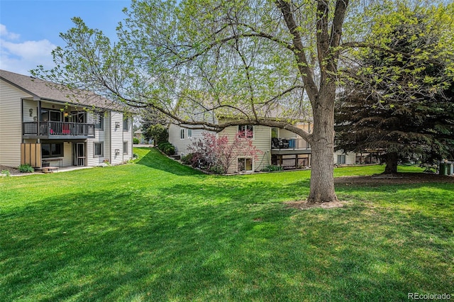 403 Captains Ct, Fort Collins, CO 80524 - view of grassy yard with a balcony