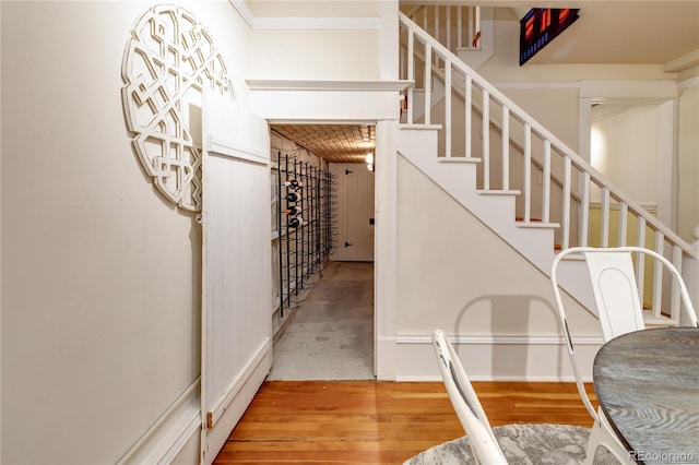 staircase with baseboards and wood finished floors