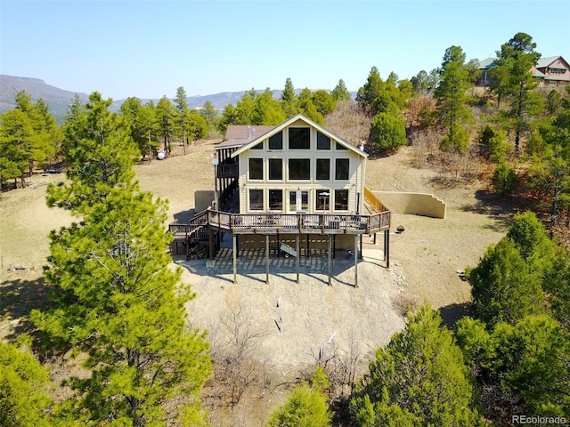 back of house featuring a wooden deck