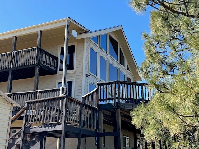 back of house featuring a wooden deck