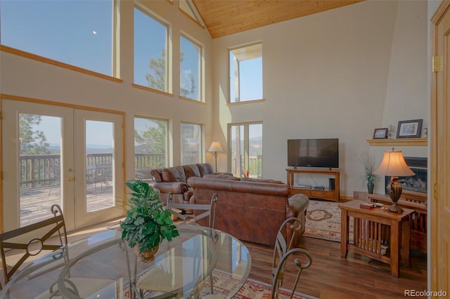 dining space featuring french doors, wood-type flooring, high vaulted ceiling, and wood ceiling