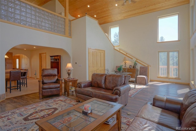 living room featuring hardwood / wood-style flooring, high vaulted ceiling, and wooden ceiling