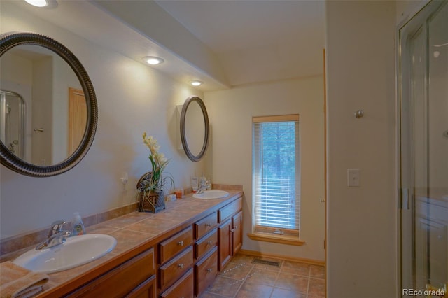 bathroom with tile floors and double vanity