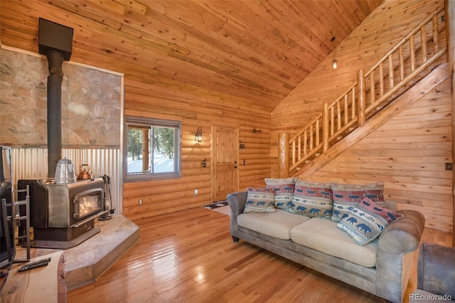 living room featuring a wood stove, high vaulted ceiling, wood ceiling, and light wood-type flooring