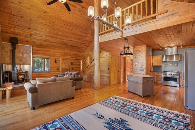 living room featuring a wood stove, wooden ceiling, high vaulted ceiling, and light hardwood / wood-style floors