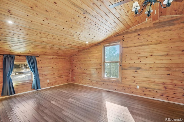 additional living space featuring wooden walls, wooden ceiling, vaulted ceiling, and hardwood / wood-style flooring