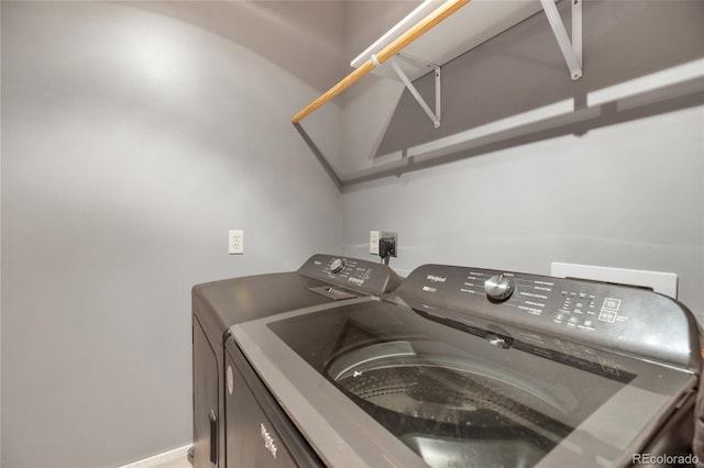 clothes washing area featuring washer and clothes dryer