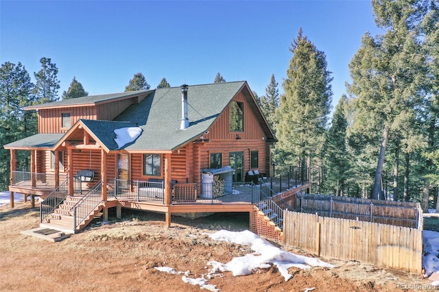 rear view of house with a wooden deck