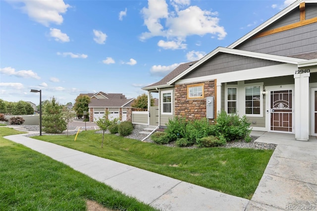 12940 Jasmine St Unit A, Thornton, CO 80602 - view of side of home with stone siding and a yard