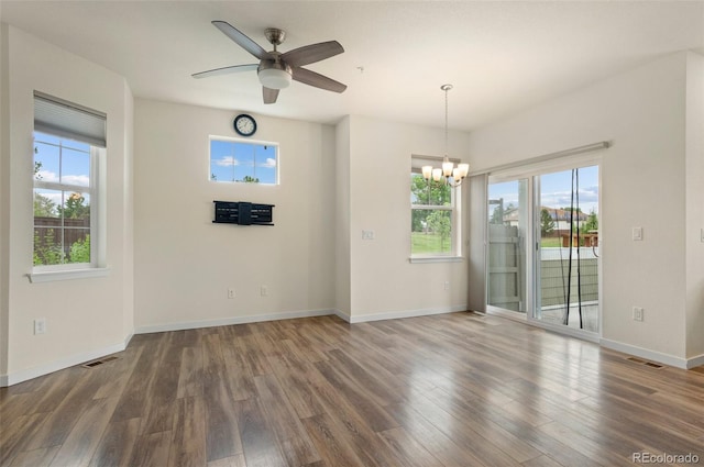 12940 Jasmine St Unit A, Thornton, CO 80602 - unfurnished dining area featuring wood finished floors, a chandelier, and ceiling fan