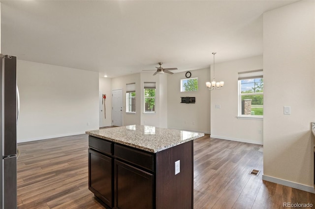 12940 Jasmine St Unit A, Thornton, CO 80602 - kitchen featuring freestanding refrigerator, wood finished floors, ceiling fan, open floor plan, and baseboards