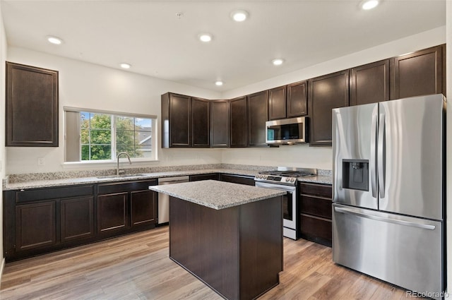 12940 Jasmine St Unit A, Thornton, CO 80602 - kitchen with stainless steel appliances, a sink, dark brown cabinets, recessed lighting, and light stone counters