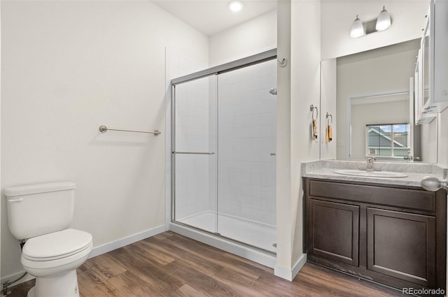 12940 Jasmine St Unit A, Thornton, CO 80602 - full bath featuring a shower stall, toilet, wood finished floors, and vanity