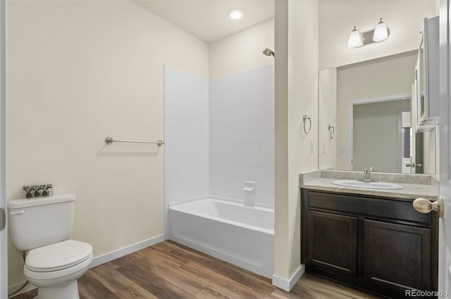 12940 Jasmine St Unit A, Thornton, CO 80602 - full bathroom with wood finished floors, toilet, vanity, and baseboards