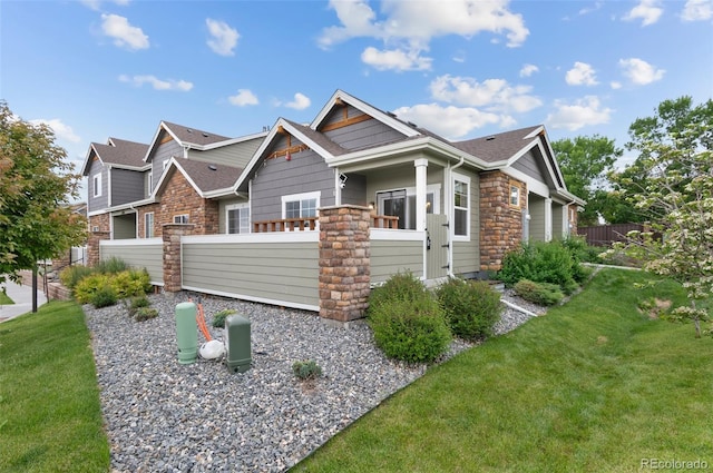 12940 Jasmine St Unit A, Thornton, CO 80602 - view of front of home featuring stone siding and roof with shingles