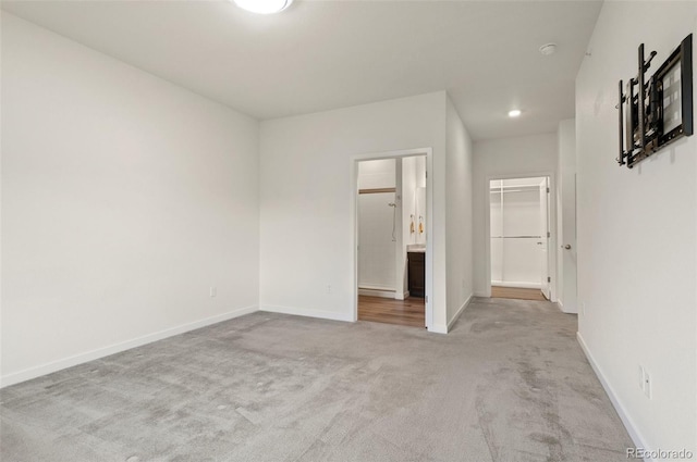 12940 Jasmine St Unit A, Thornton, CO 80602 - unfurnished bedroom with a spacious closet, carpet flooring, baseboards, a closet, and ensuite bath