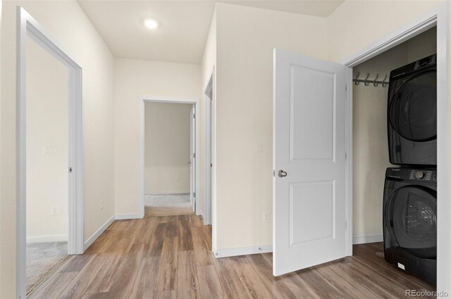 12940 Jasmine St Unit A, Thornton, CO 80602 - laundry room with stacked washer / drying machine, wood finished floors, and recessed lighting