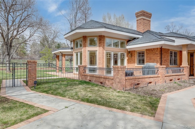 view of home's exterior featuring brick siding, crawl space, fence, and a lawn